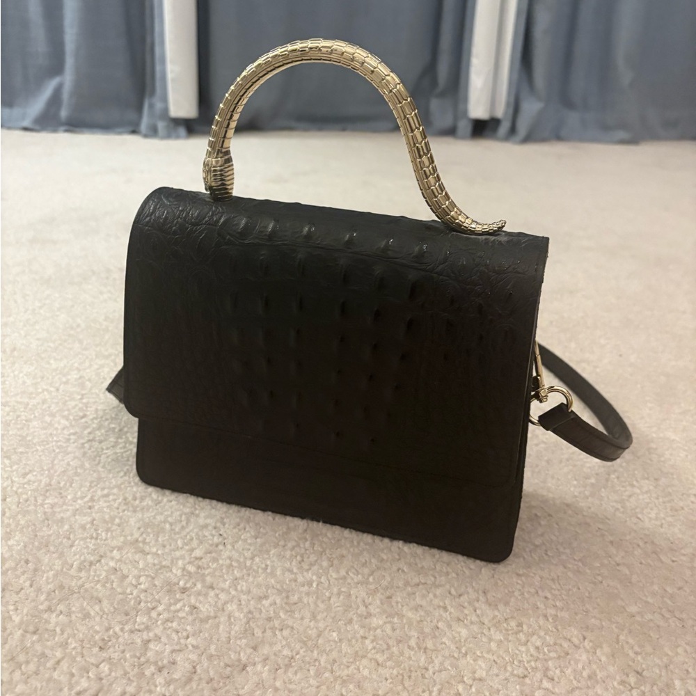 Elegant Black Handbag with Gold Handle and Real Leather